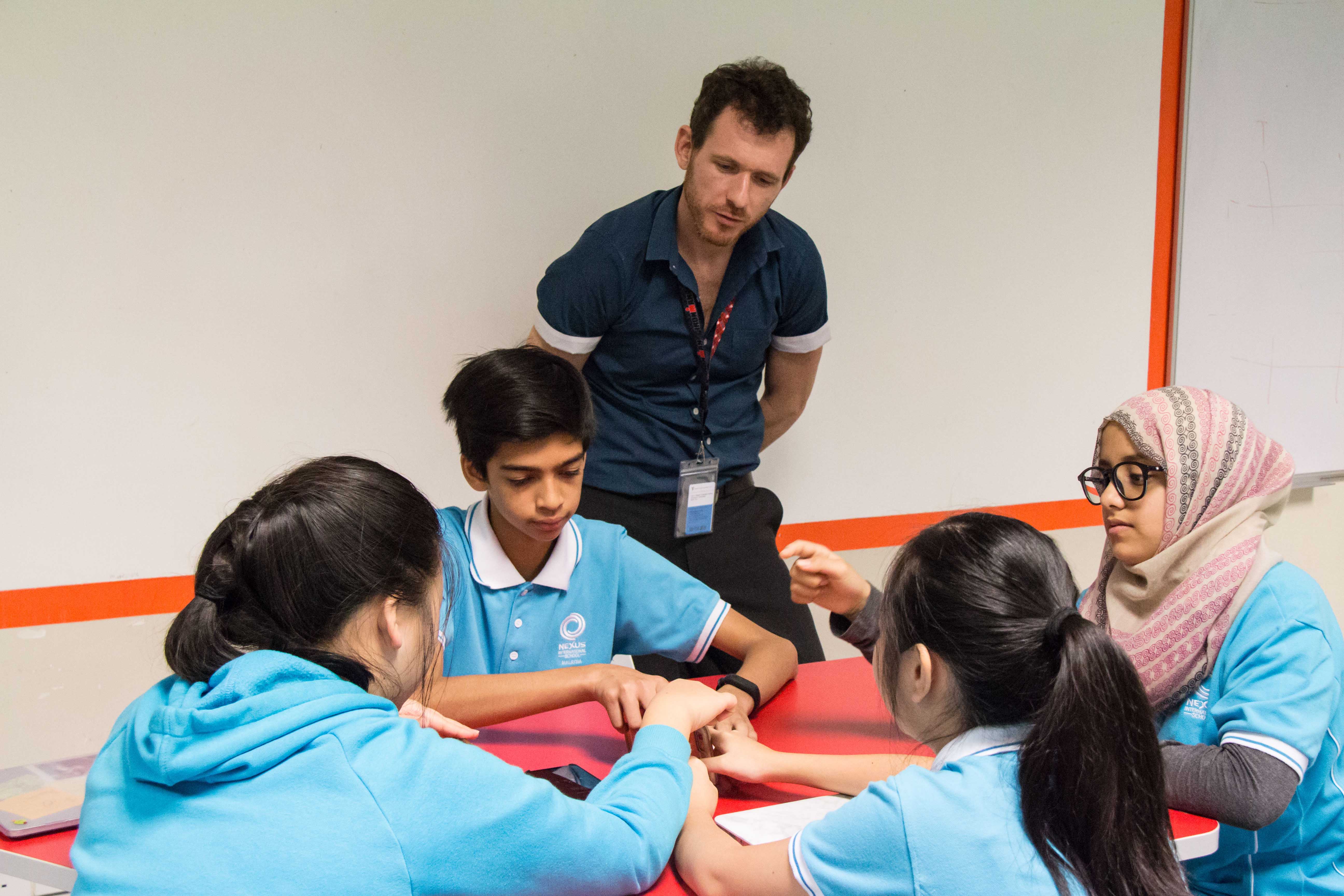 This week, a mind-boggling situation kept the middle school learners busy in the hub space. A cosy space designed for collaborative learning tasks, the hub space is where our learners go to enrich their understanding of various topics that often last for 2-3 lessons. This time around, the learners came together to solve a problem called the Fleas Problem. They gathered in groups of mixed ability and brainstormed using their algebra and sequences skills. The rule was to discover the minimum number of moves that it would take for all the fleas to be stood up. However, the ultimate objective was to try to discover if there was an underlying formula that would calculate the number of moves for any amount of fleas. Much to the learners’ delight, they were given the freedom to approach this problem however they wanted. Some chose to become the fleas themselves, some used mobile phones or pens to represent the fleas whilst others formulated complex notation on paper. The learners enjoyed seeking solutions in groups This week, a mind-boggling situation kept the middle school learners busy in the hub space. A cosy space designed for collaborative learning tasks, the hub space is where our learners go to enrich their understanding of various topics that often last for 2-3 lessons. This time around, the learners came together to solve a problem called the Fleas Problem. They gathered in groups of mixed ability and brainstormed using their algebra and sequences skills. The rule was to discover the minimum number of moves t