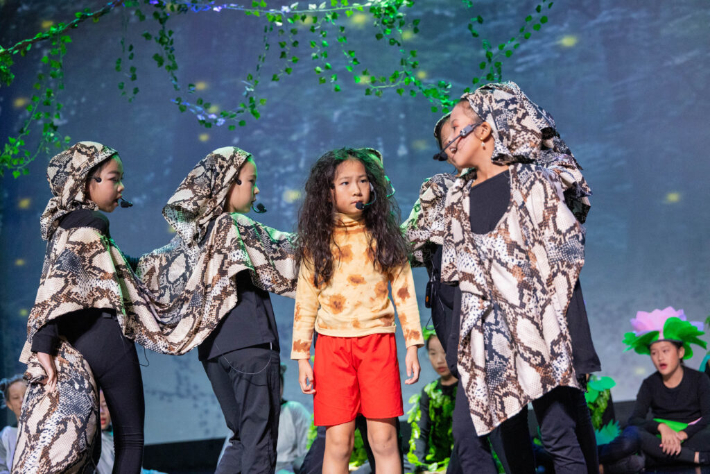 Nexus learner performing as Mowgli during The Jungle Book Primary School production at Nexus International School Malaysia.