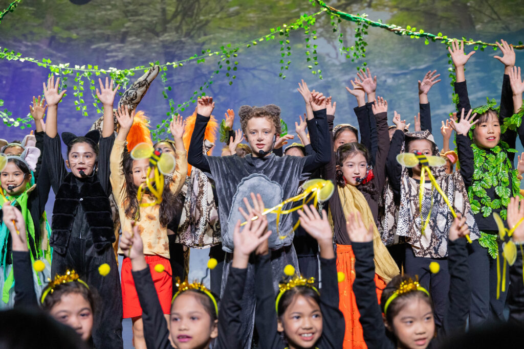 Primary learners performing together during The Jungle Book Primary School production at Nexus International School Malaysia.