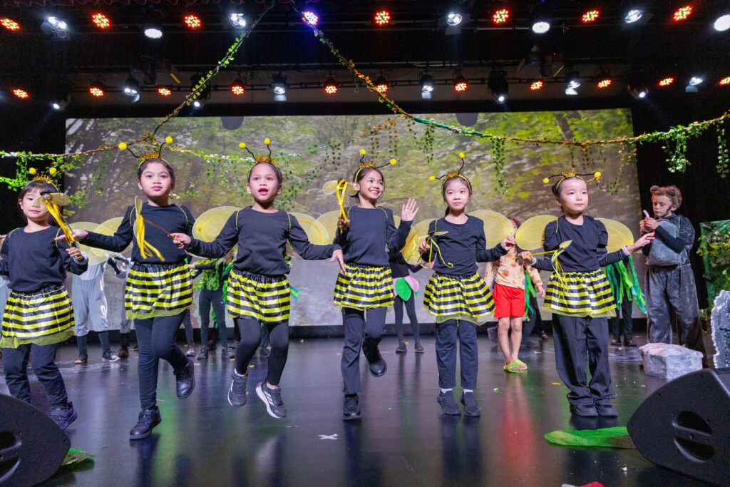 Learners dressed as bees performing during The Jungle Book Primary School production at Nexus International School Malaysia.